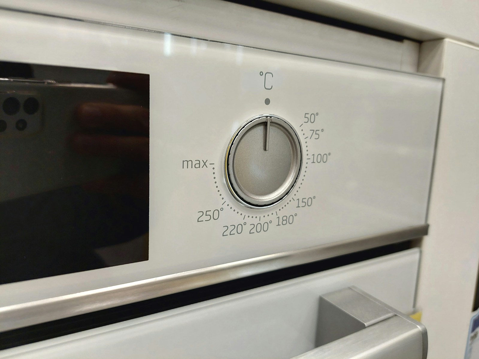 a close up of a stove with a knob on it